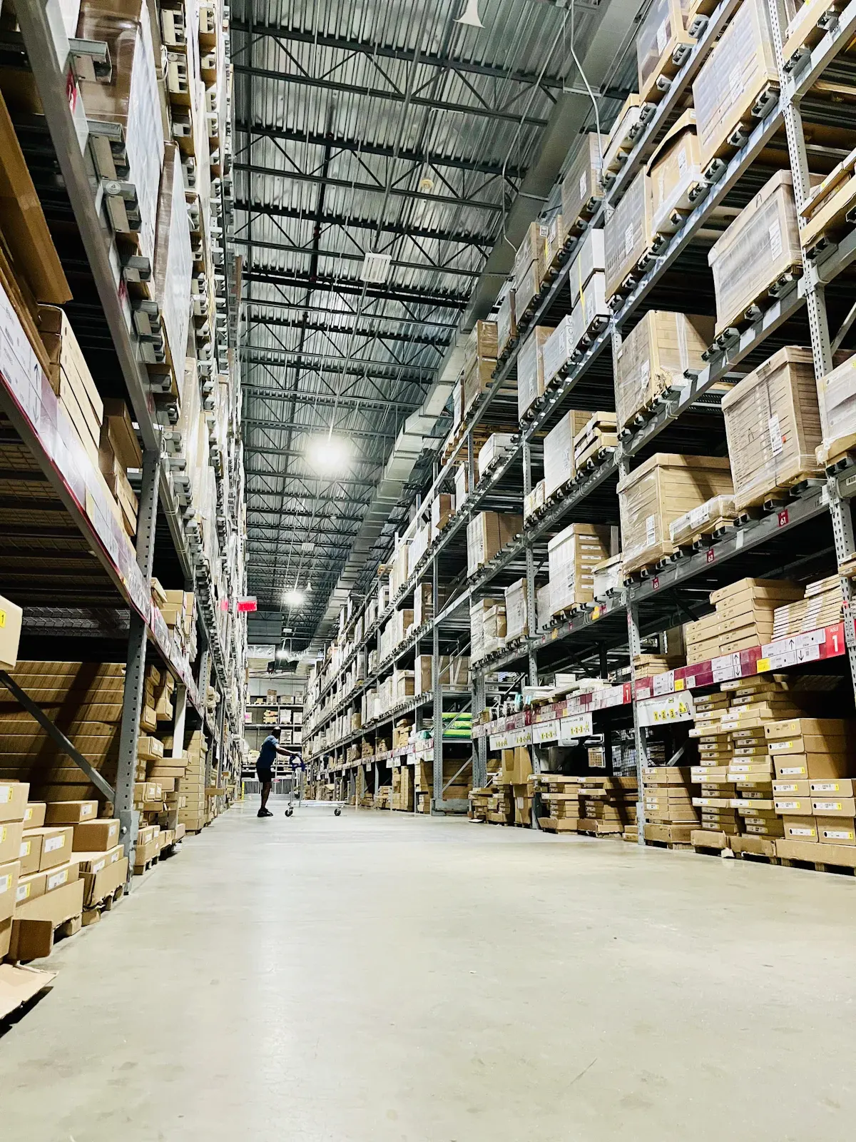 Tall shelves of cartons in a warehouse aisle