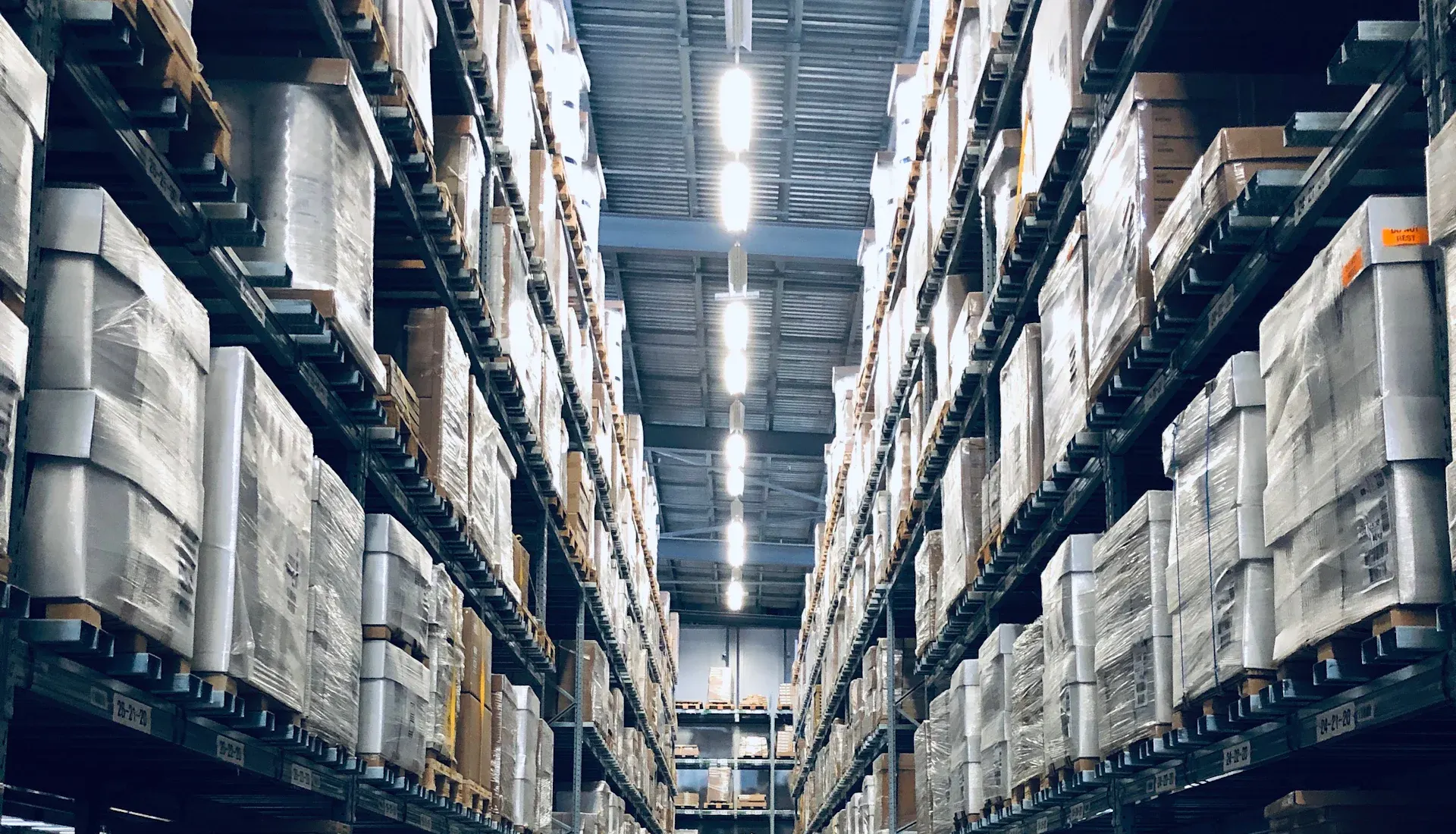 A large warehouse with tall racks of stock