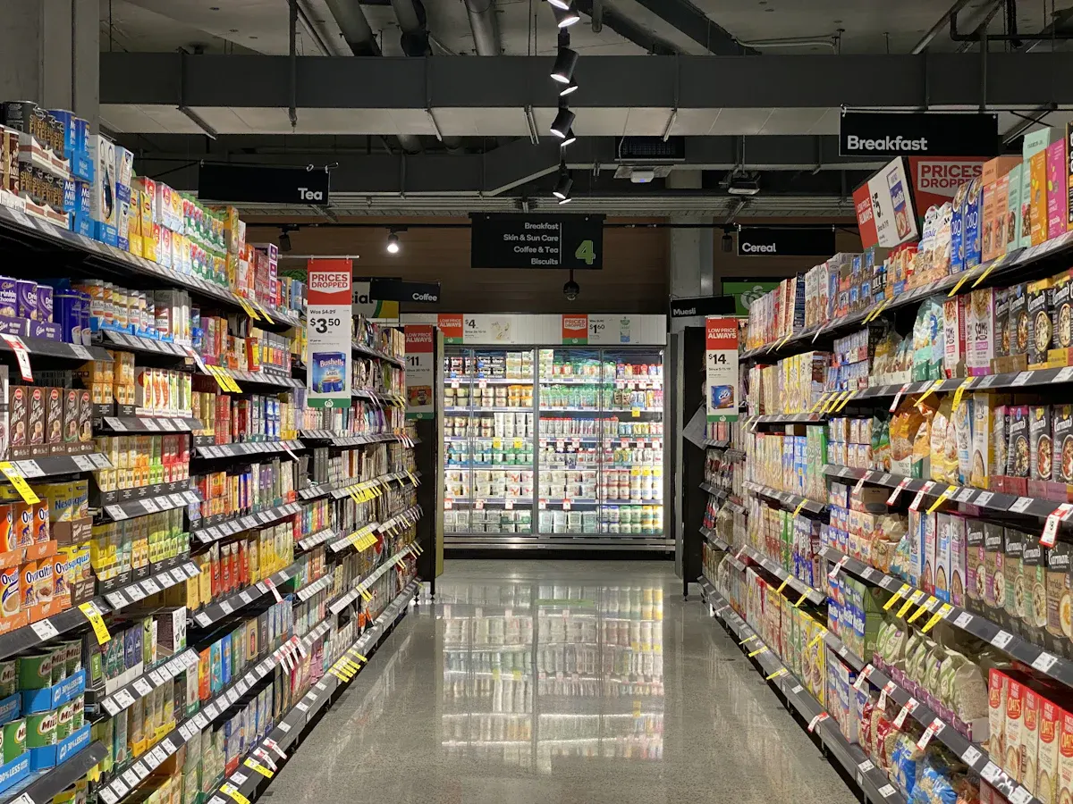 A supermarket aisle with fully stocked shelves